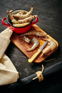 Fresh, delicious raw tiger prawns cut on a wooden board Stock Photos