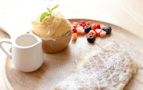 Fresh dessert soft vanila roti with ice cream ,syrup ,strawberry and bluebe.. Stock Photos