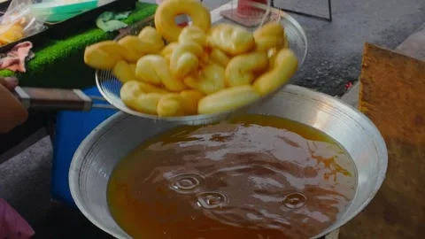 Fresh Donuts Being Fried in Hot Oil at Thai Night Market Stock Footage 324861683