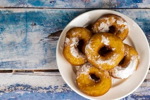 Fresh donuts with powdered sugar on the table Stock Photos
