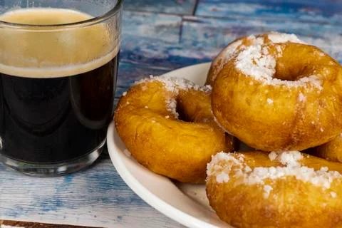 Fresh donuts with powdered sugar on the table Stock Photos