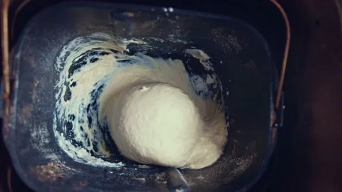 Fresh dough mixing in bread-maker Stock Footage 136427779