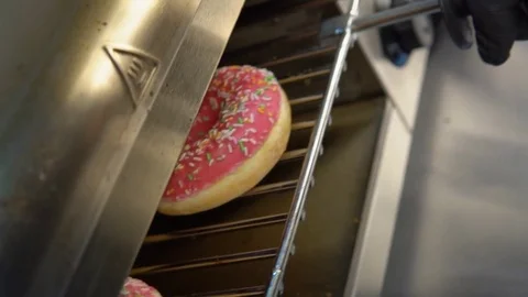 Fresh doughnuts on a baking sheet 스톡 동영상 84817307