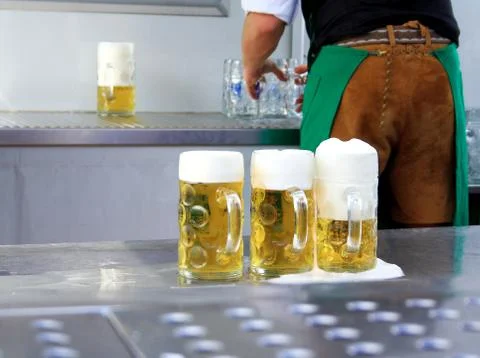 Fresh draft three liters beer at oktoberfest and worker Stock Photos