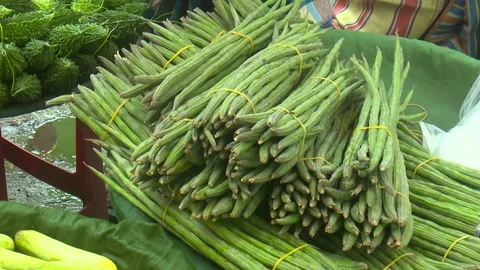 Fresh drumstick vegetables arranged in a local market Stock Footage 320034094