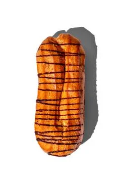 Fresh eclair with chocolate glaze isolated on a white background, hard shadow Stock Photos