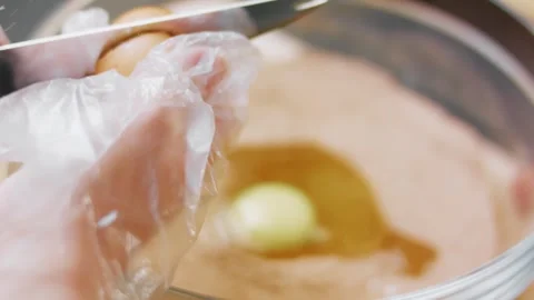 Fresh egg dropped into homemade cake batter, 4K Stock Footage 341120845