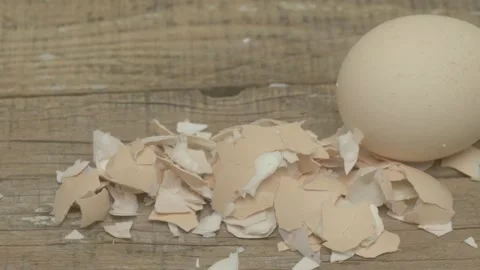 A Fresh Egg That Has a Cracked Shell on a Rustic Wooden Surface Ready for Stockbeeldmateriaal 281636660