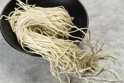 Fresh Egg Noodles with Raw Egg and Flour on Wooden Board Stock Photos