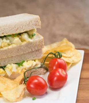 Fresh egg on white sandwich in rustic kitchen setting Stock Photos
