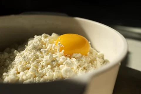 A Fresh Egg Yolk Served Generously on Top of Creamy Cottage Cheese for a Stock Photos