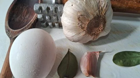 Fresh eggs and garlic on a kitchen counter. Natural ingredients for cooking or Stock Photos