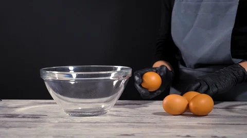 Fresh eggs falling into bowl. Egg yolk falling in glass bowl. Separating the Stock Footage 86534472