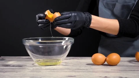 Fresh eggs falling into bowl. Egg yolk falling in glass bowl. Separating the Stock Footage 86534572