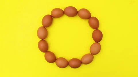 Fresh eggs making circle on yellow theme. Stop motion Stock Footage 149324181
