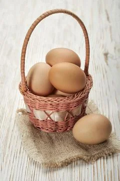 Fresh eggs in a rustic basket Stock Photos