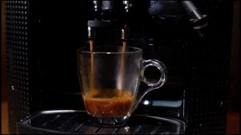 Fresh espesso making from black shiny coffee machine in little transparent glass Video stock 255051773