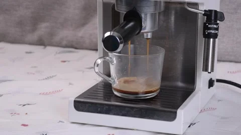 Fresh Espresso Dripping from Coffee Machine into Glass Cup Stock Footage 340148743