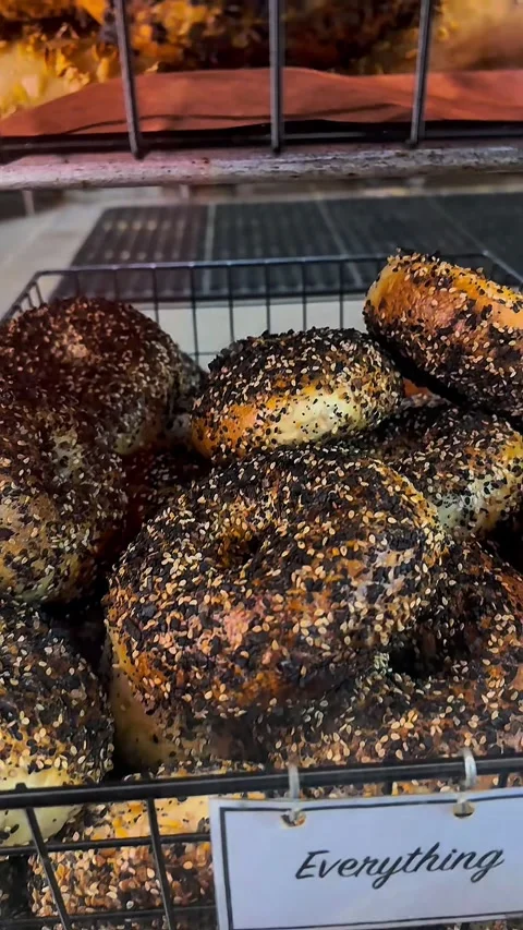 Fresh Everything Bagels in Wire Basket - New York City Deli Style Stock Footage 329371565