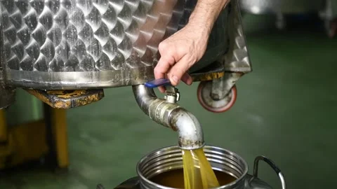 Fresh extra virgin olive oil falling in recipient Stock Footage 140217031