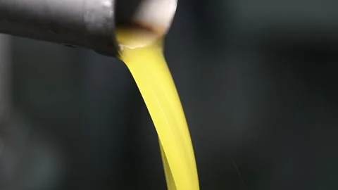 Fresh extra virgin olive oil falling in recipient, Stock Footage 140218560