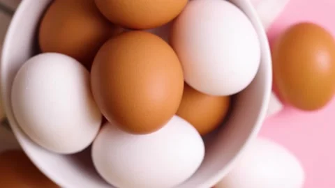 Fresh farm chicken eggs on a colored background Stock Footage 236242438