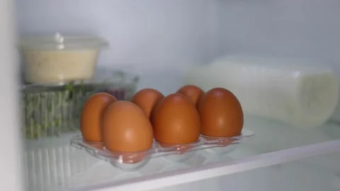 Fresh farm eggs in the fridge Stock Footage 237892518