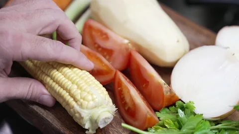 Fresh farm vegetables. tomatoes, corn, potato, basil green onions on table. Stock Footage 156060469