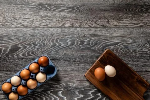 Fresh farmer market eggs on a kitchen table with utensils Stock Photos