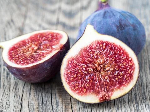 A fresh Fig and cut off half Stock Photos