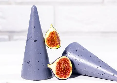 Fresh Fig with mint leaf on gray stands and podiums over white background, He Stock Photos