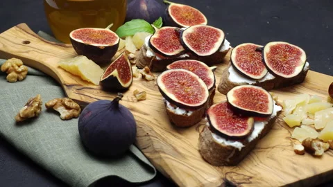 Fresh fig slice on wooden cutting board. Slow motion Stock Footage