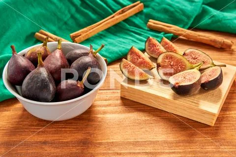 Fresh figs on a with bowl and some sliced figs ready to eat. Stock Photos
