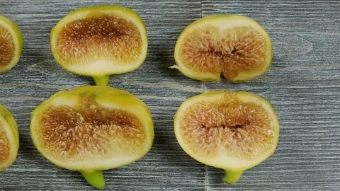 Fresh figs cut in half on a table. Overhead slider shot. Stock Footage 113771294