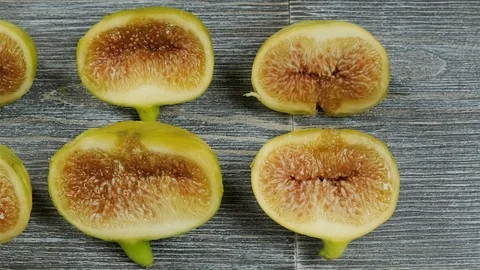 Fresh figs cut in half on a table. Overhead slider shot. Stock Footage 113771821