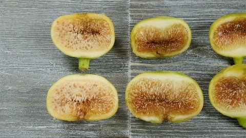 Fresh figs cut in half on a table. Overhead slider shot. Stock Footage 113772714