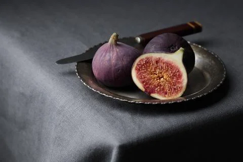 Fresh figs on a dark background, whole and a piece, ripe, delicious and sweet Stock Photos