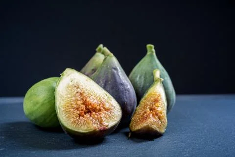 Fresh figs on a dark slate table with black background. Stock Photos