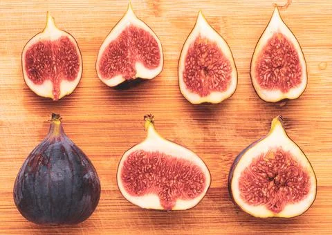 Fresh figs isolated on wooden background. Stock Photos
