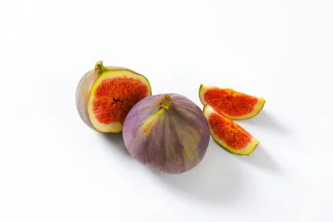 Fresh figs with one sliced open showing inside Stock Photos