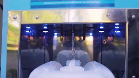Fresh filtered water pouring into a plastic canister at a self-service vending m Stock Footage 339879142