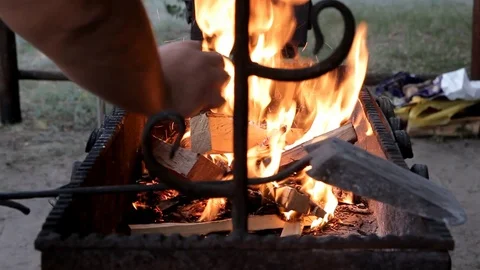 Fresh firewood is thrown into the brazier Stock Footage 113231881