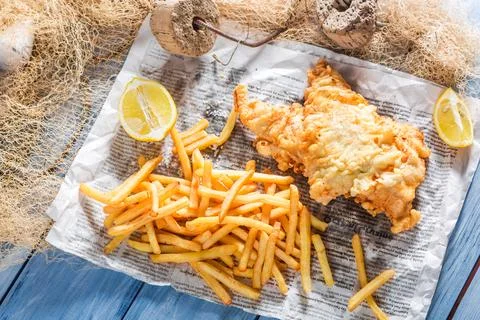 Fresh fish and chips served in paper Stock Photos