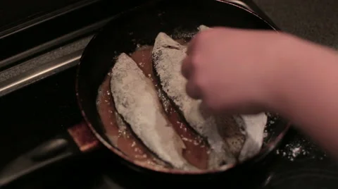Fresh fish is being fried on the frying pan Stock Footage 58567416