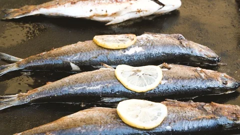 Fresh fish with lemon on grill Stock Footage 105118938