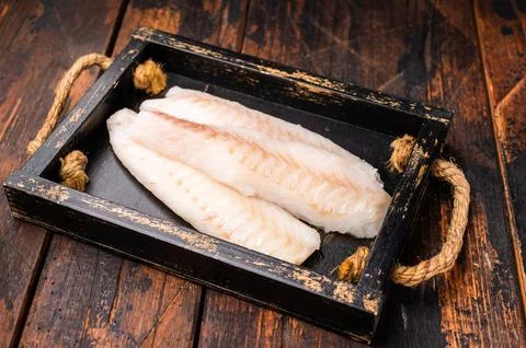 Fresh fish meat, Raw cod loin pieces without skin in wooden tray. wooden ba.. Stock Photos