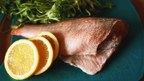 Fresh fish, raw cod fillets with addition of herbs and lemon Stock Photos