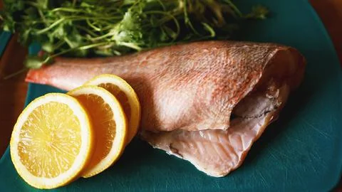 Fresh fish, raw cod fillets with addition of herbs and lemon Stock Photos