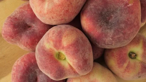 Fresh flat Saturn peaches rotating slowly Stock Footage 343435622
