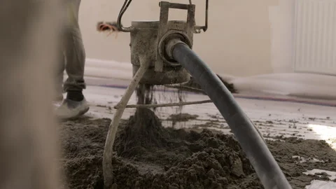 Fresh floor screed pumped and spread during apartment construction Vídeo Stock 343449682